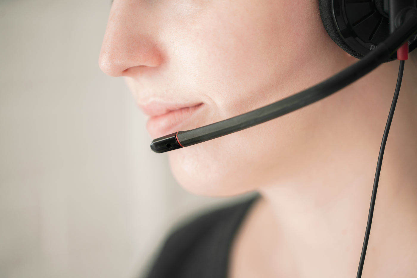 Person with headset mic on mouth.
