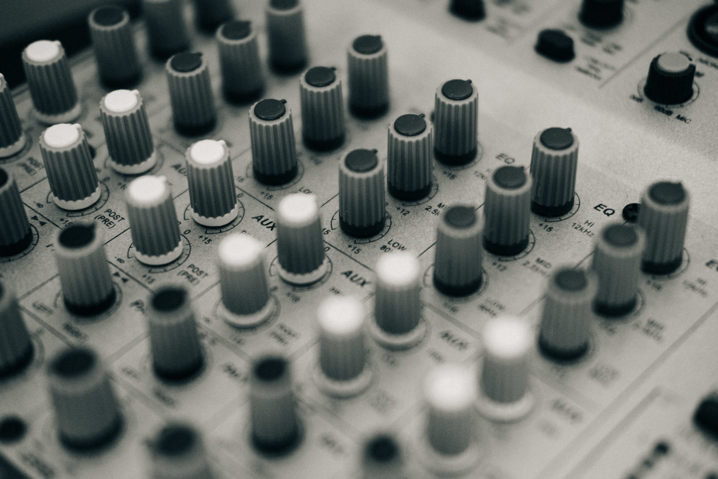 Sound board close up on EQ and Aux dials. 